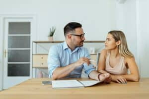 Private tutor questioning beautiful college student, portrait.