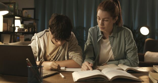 Tutor helping a student with his homework